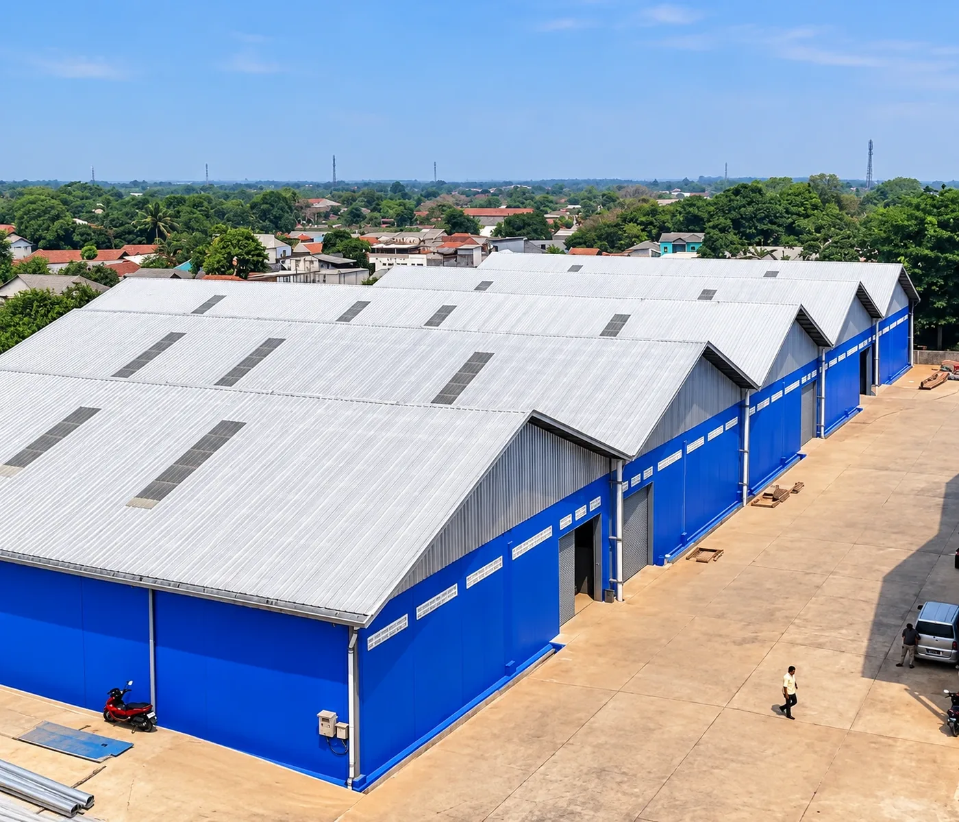 Visualisasi kawasan pergudangan dengan bangunan beratap metal dan dinding biru